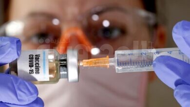 File Photo: A Woman Holds A Small Bottle Labeled With A "vaccine Covid 19" Sticker And A Medical Syringe In This Illustration